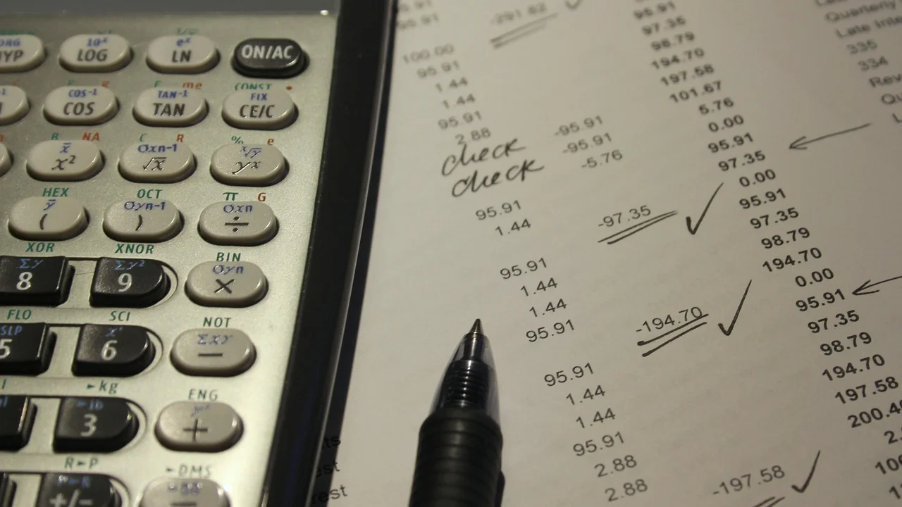 Calculadora e documentos usados na conferência tributária