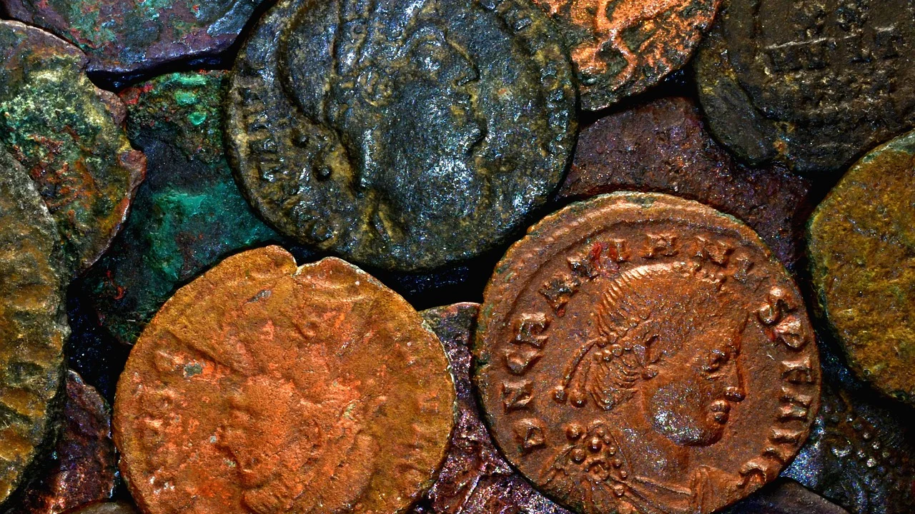 Catálogo numismático aberto ao lado de moedas colecionáveis.